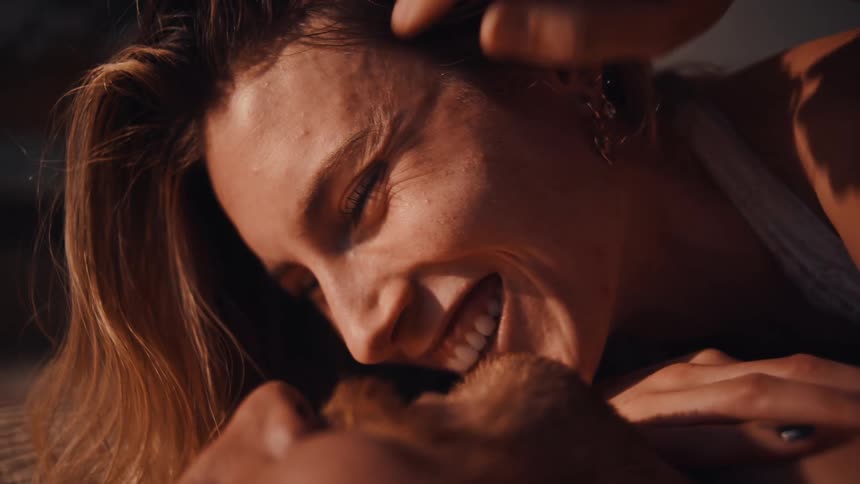 A man and woman cuddling and laughing