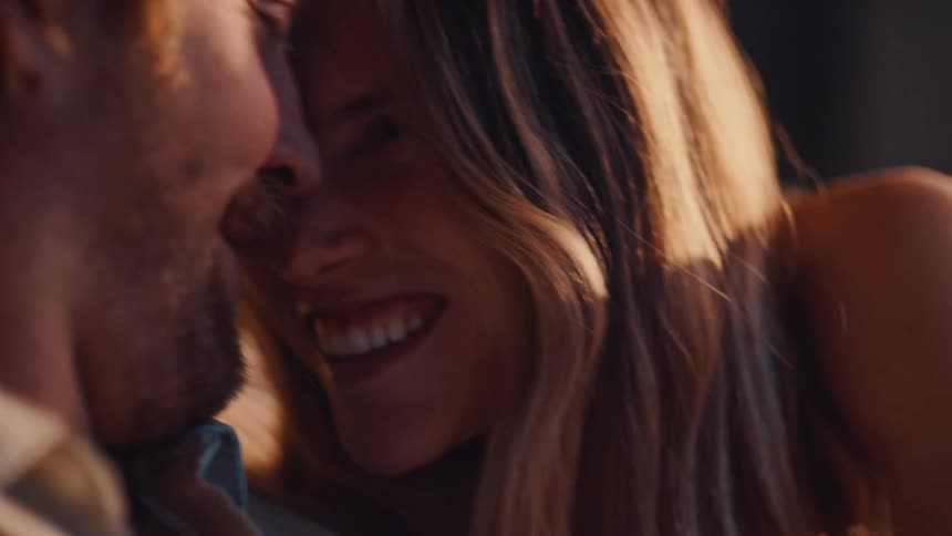 The couple get in close and laugh together