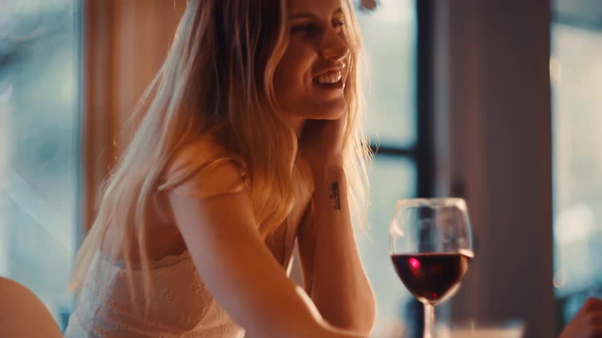 A woman drinking wine in a room