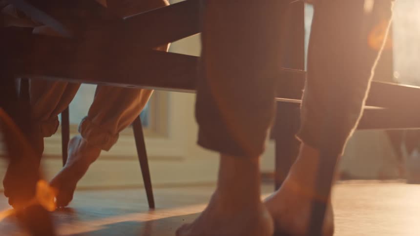 A picture of two peoples feet at a table