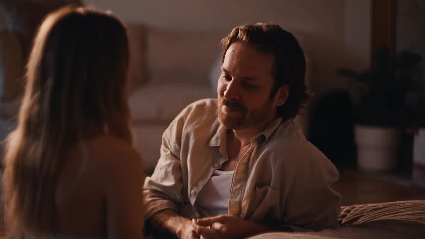 The couple are having a conversation at home
