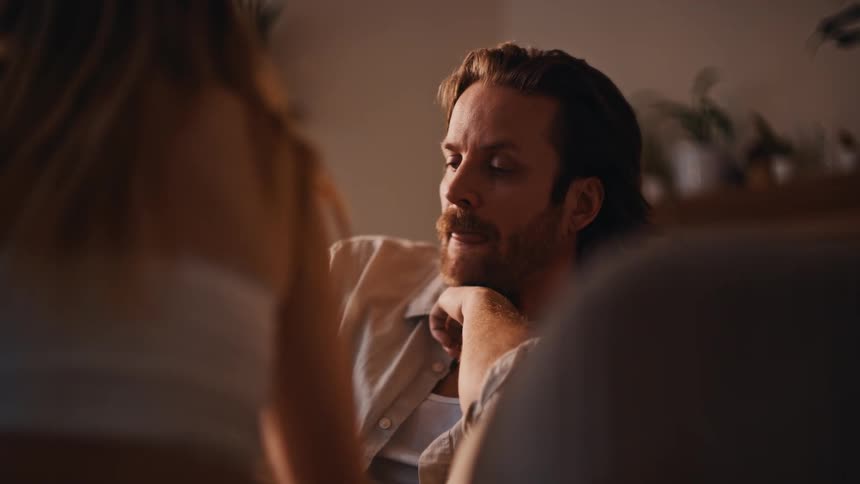The man is listening to a woman before he begins talking