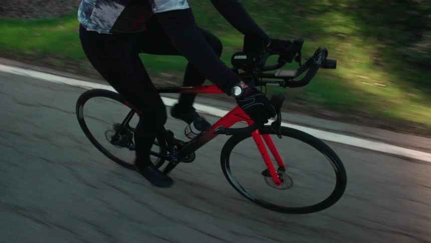 The man is cycling on the road