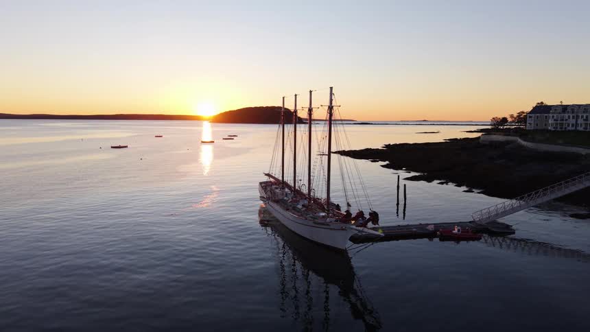 Aerial of a ship docked at a port at sunset