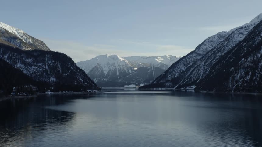 River valley between snow covered forested mountains
