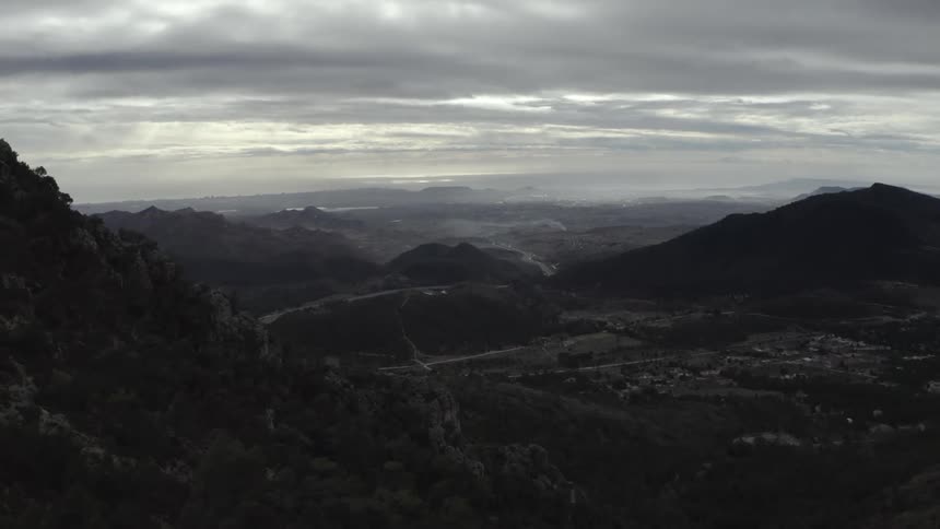 An aerial view of a city located near some mountains