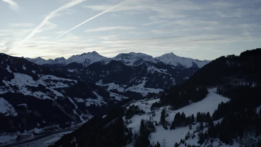 An aerial view of some mountains covered in snow