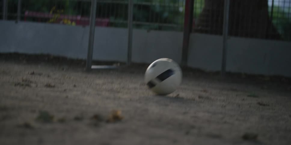 Legs of three people playing soccer