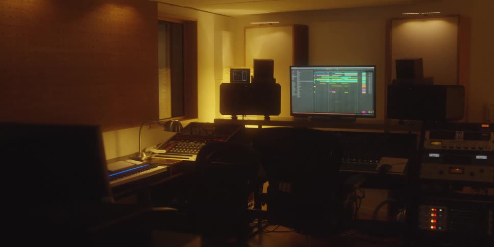 Recording studio displays active daw workstation surrounded by professional audio equipment