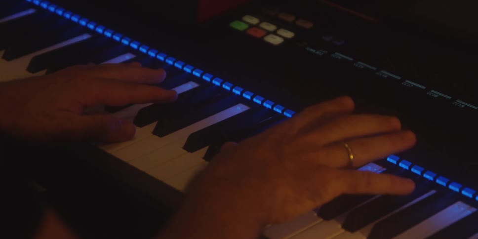 The man is playing the keyboard