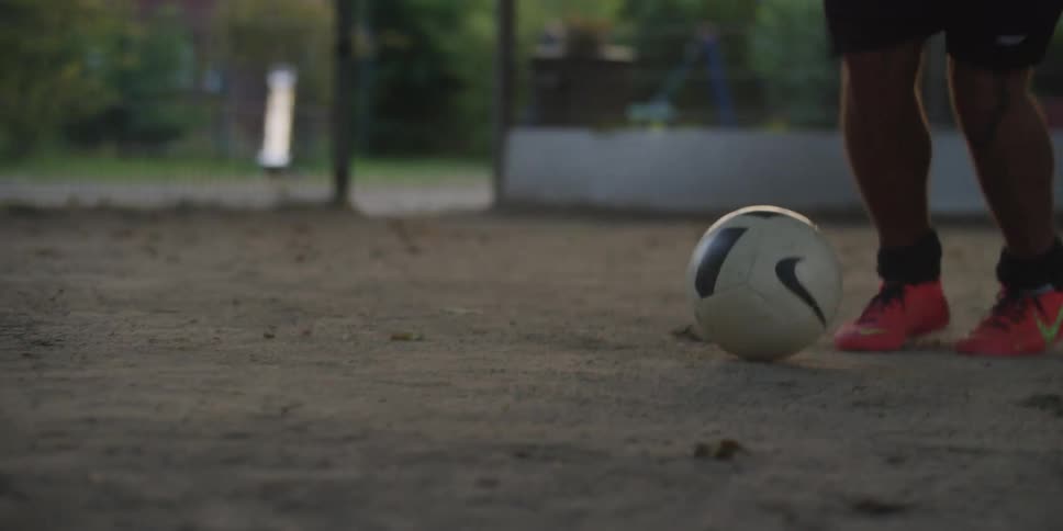 A person dribbles a soccer ball while trying to avoid defenders