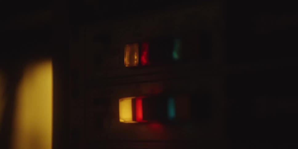 Control panel displays rectangular buttons lit in red yellow and blue under low light