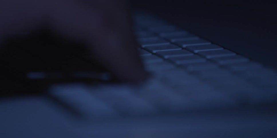 The person is typing on his keyboard