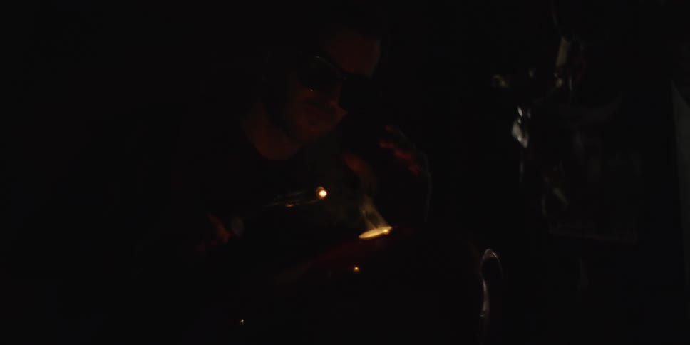 The welder is welding metal in the dark