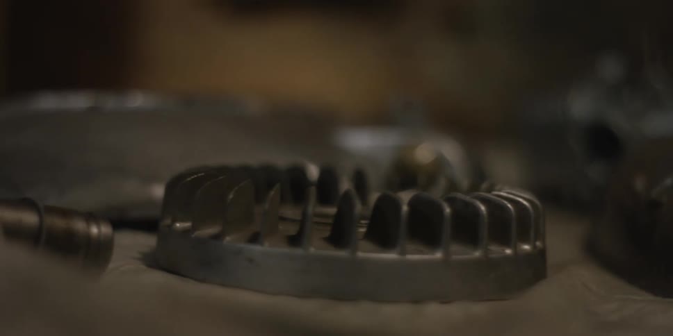 Circular metal components with toothed edges rest on a surface with shallow focus