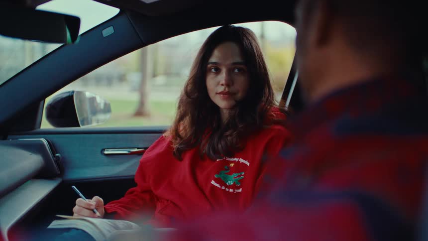 A man and woman talking in a car