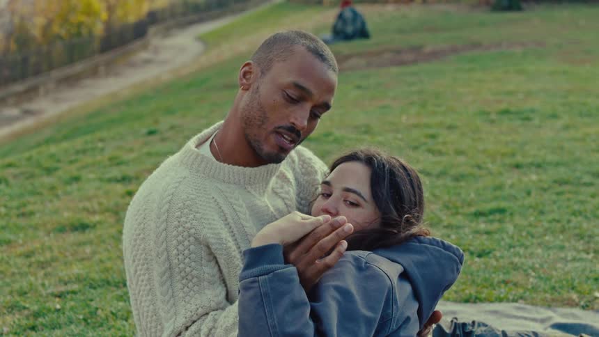 A man and woman cuddling outdoors
