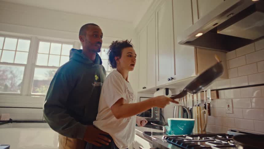 A man and woman cooking in a kitchen
