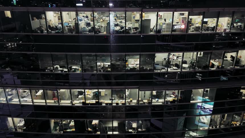 The lights are on in the office building at night