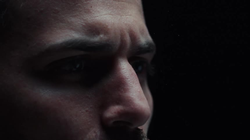 Close up portrait of a male gymnast in a dark room