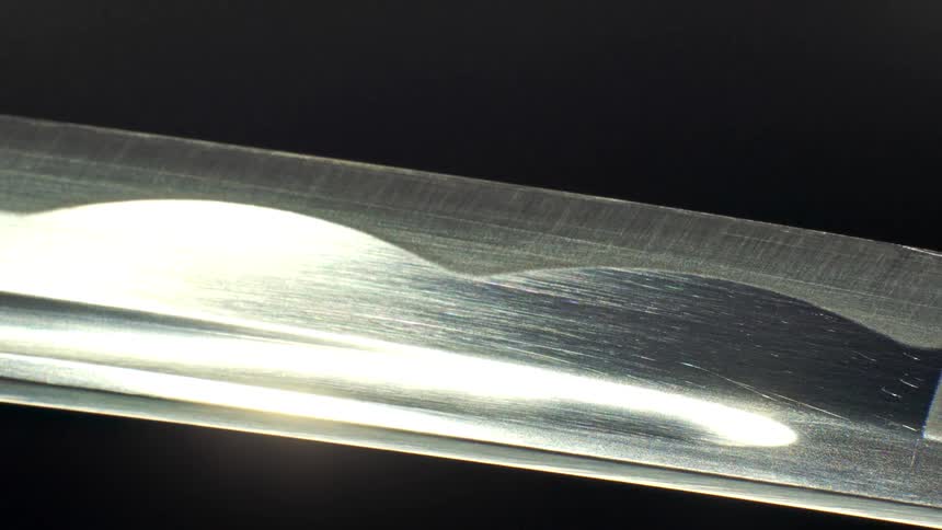 Katana blade in closeup with the steel pattern visible