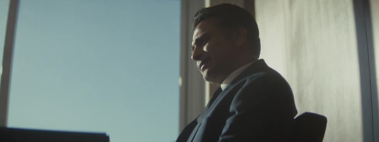 Two men stand up and talk in an office room