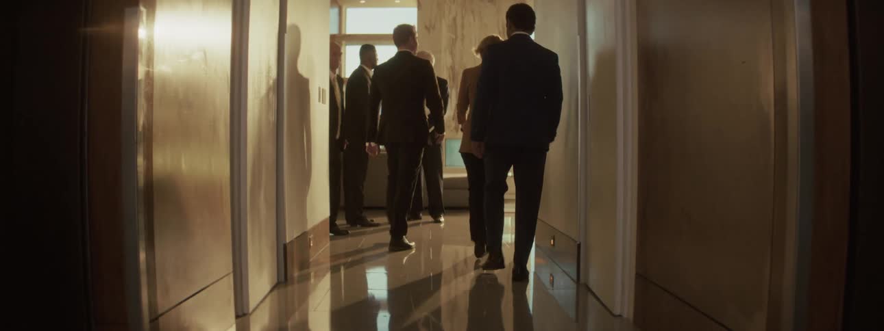 People walk down the hall together in the office
