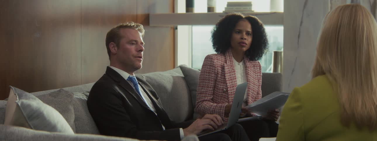 Four business people two men and two women discussing in office at midday