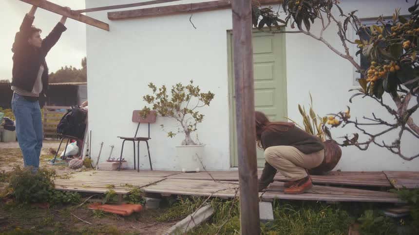 A couple talking outside a house