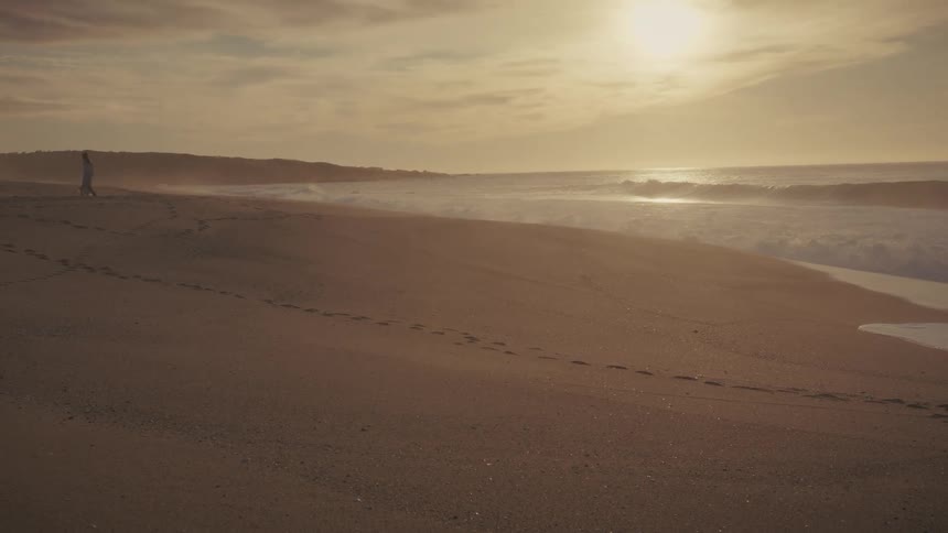 Woman walking on the sand