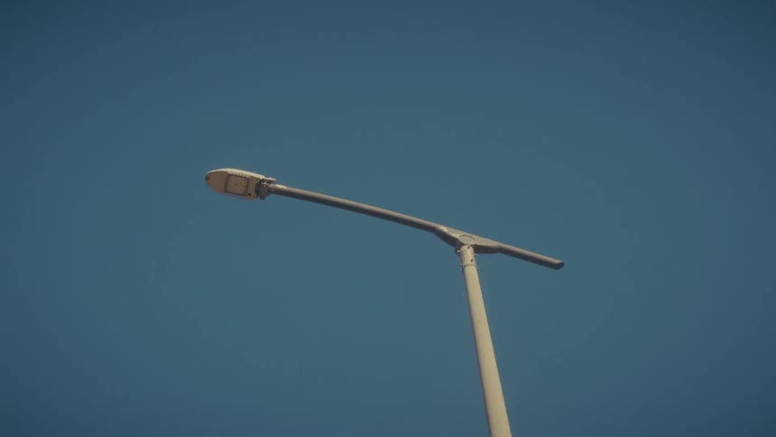 Street light on a pole under a clear blue sky