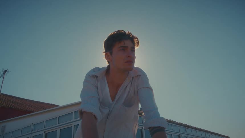 A man with his shirt billowing in the breeze