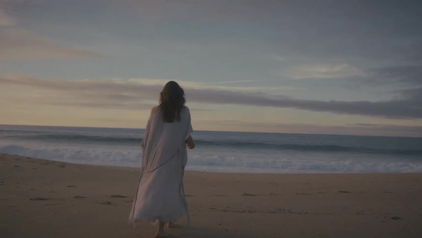 A woman walking on a beach