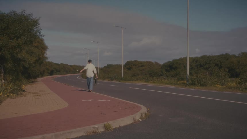 A man walking barefoot outdoors