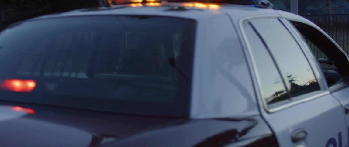 Cop drives a police car with lights flashing