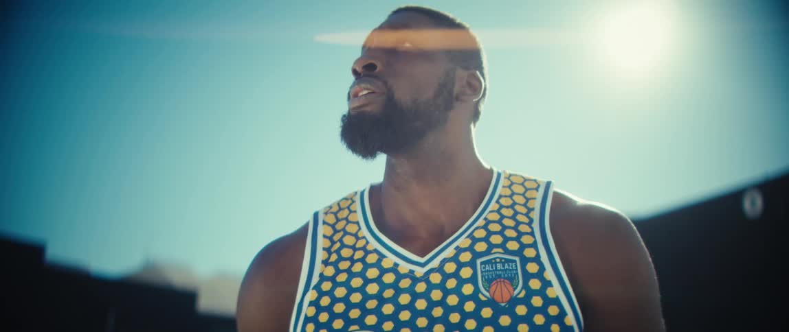 A man holding a basketball outdoors