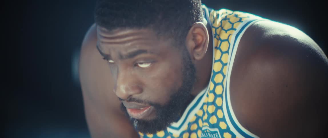 Man in closeup wearing a sports jersey during physical activity