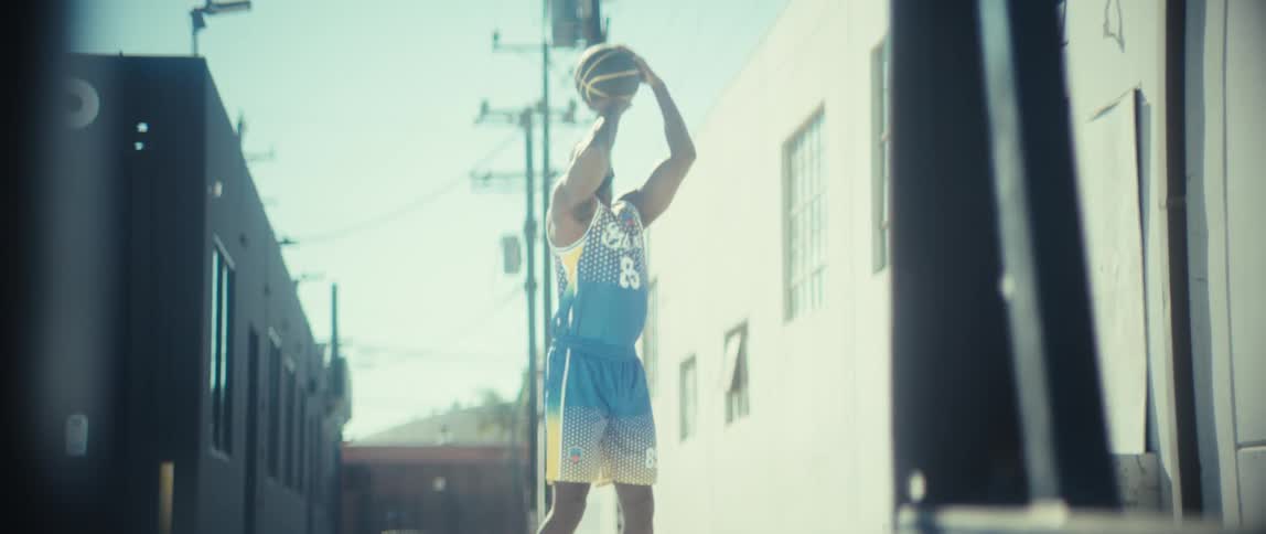The man shoots and scores the basketball