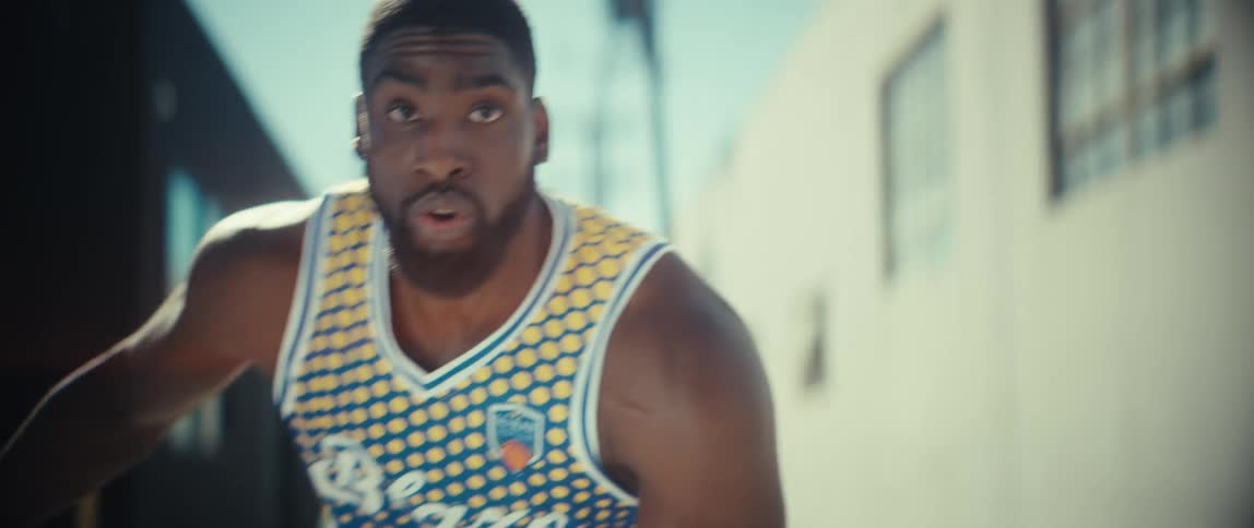 A man playing basketball outdoors