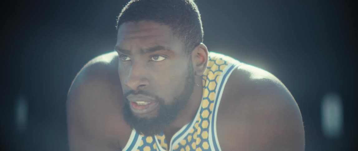 Close up of a black male athlete at an outdoor basketball court during daytime