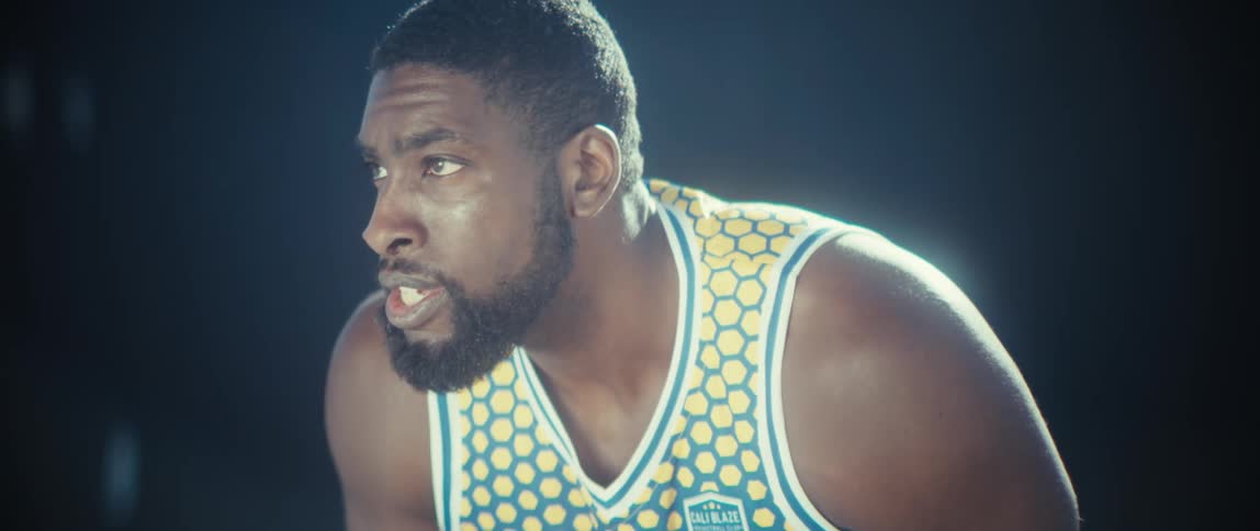 Close up of a young black male basketball athlete preparing to play in an outdoor court during daytime
