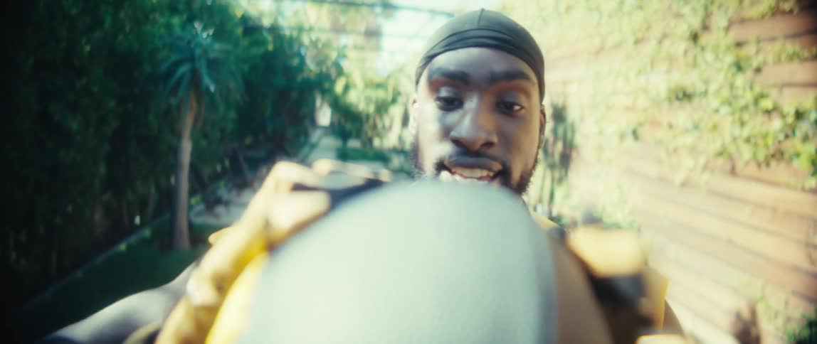The football is thrown back and forth in the alley