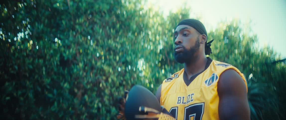 A man playing football outdoors
