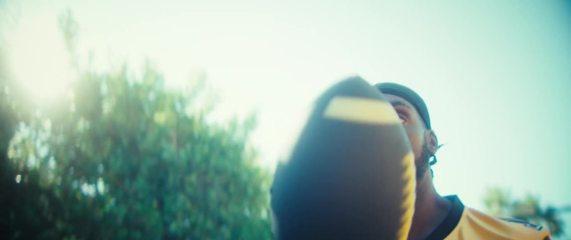 A man playing with a football outdoors