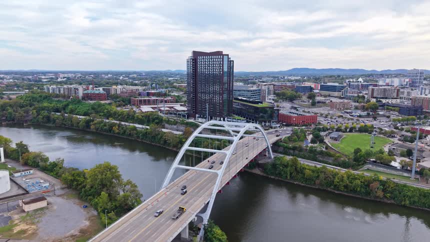 An aerial view of a city with a bridge over water