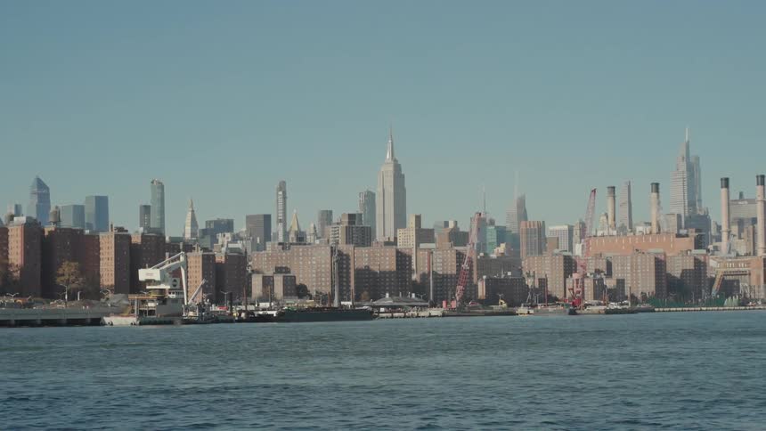 Metropolitan city along the coast with towers and skyscrapers