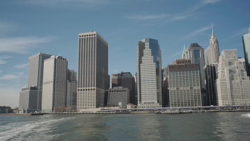 A city skyline with a waterway and skyscrapers lining the city on a sunny day