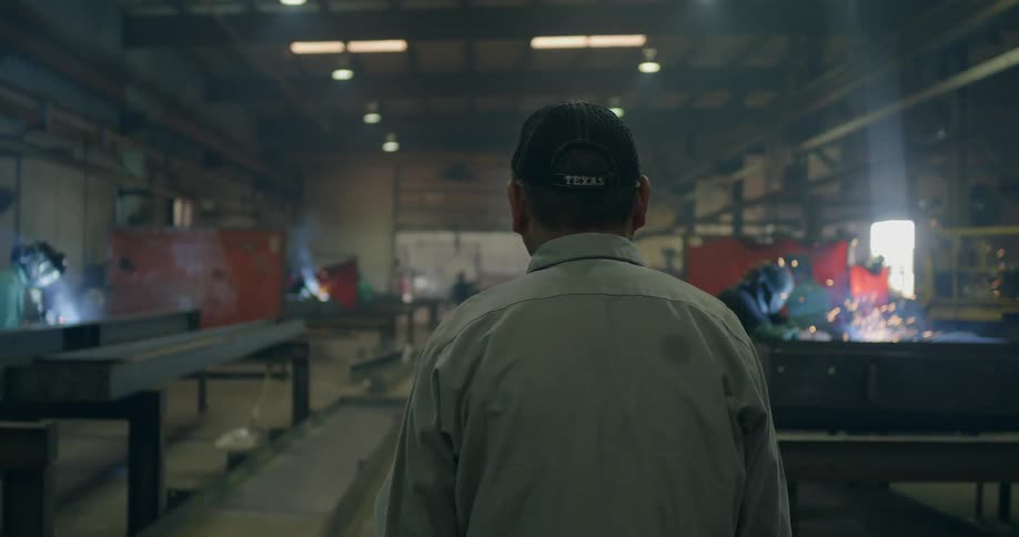 A man walks through a steel factory