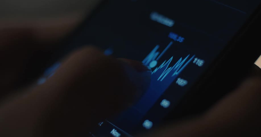 The person is scrolling through a stock feed on their cell phone