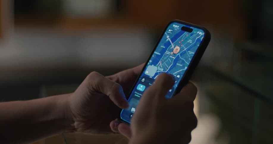 A person holds a smartphone scrolling through restaurant listings and using a streetlevel map view to find their destination in new york city